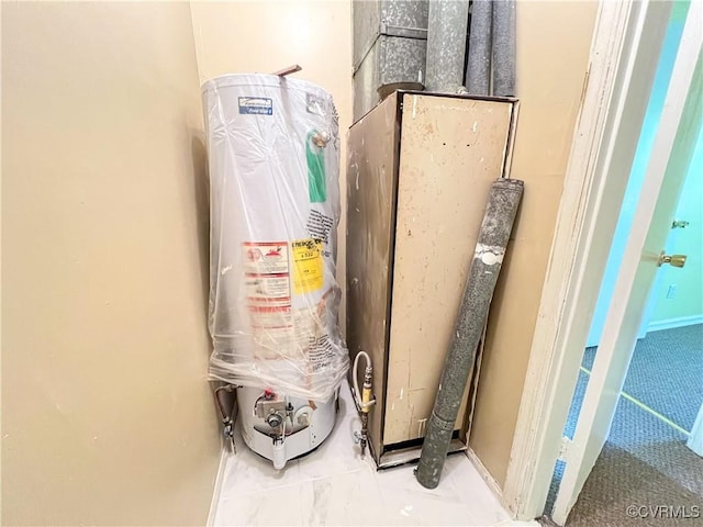 utility room featuring gas water heater