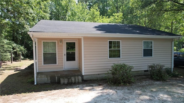 exterior space featuring a shingled roof and crawl space