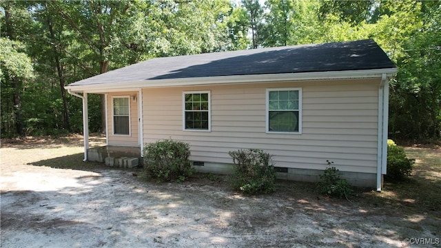 view of front of house with crawl space and roof with shingles