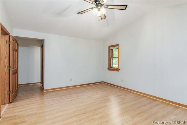 empty room featuring vaulted ceiling, ceiling fan, and light hardwood / wood-style floors