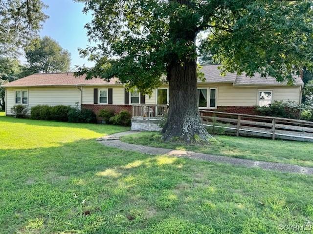 ranch-style home with fence, a front lawn, and brick siding