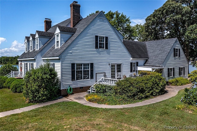 rear view of property with a yard and a deck