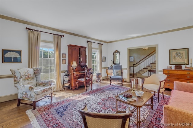 living room with crown molding and light wood-type flooring