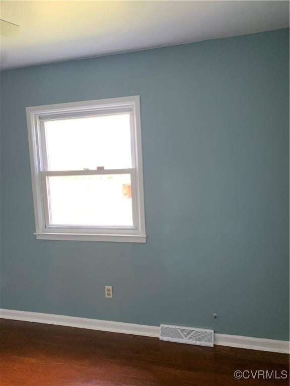 unfurnished room with dark wood-type flooring