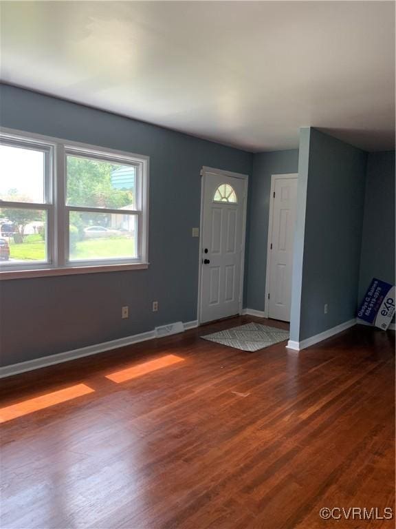 entryway with dark hardwood / wood-style flooring