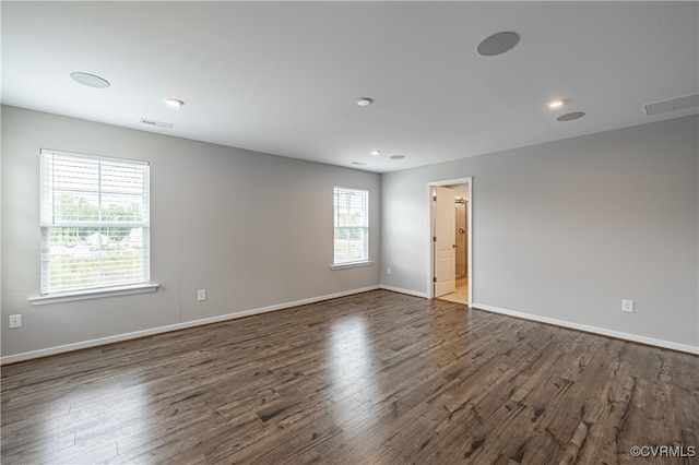 unfurnished room with dark wood-type flooring