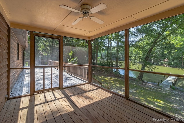 unfurnished sunroom with ceiling fan