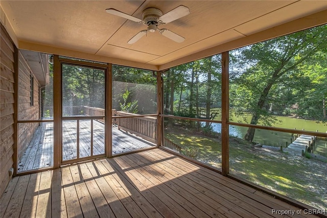 unfurnished sunroom featuring ceiling fan