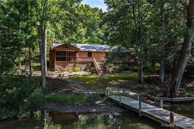 back of property featuring a deck with water view