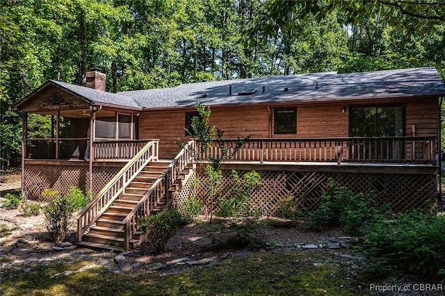 view of front of home with a sunroom and a deck