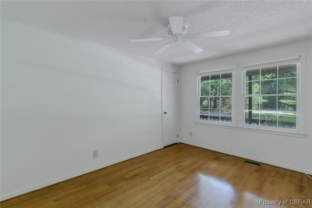 unfurnished room featuring hardwood / wood-style flooring, a textured ceiling, and ceiling fan