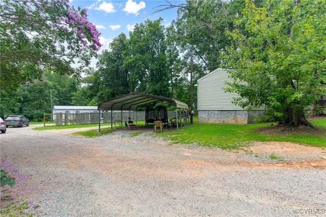 exterior space with a yard and a carport