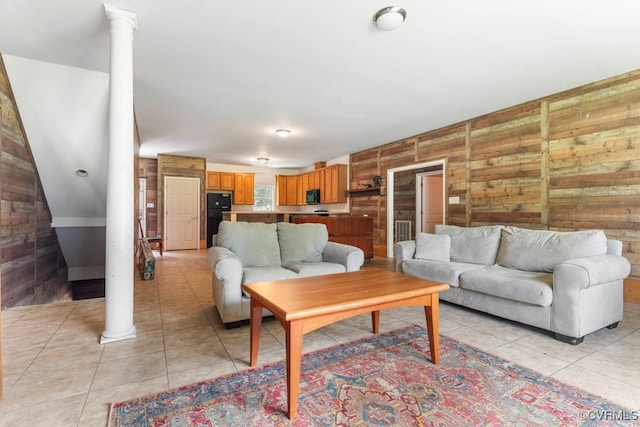 tiled living room featuring wooden walls and decorative columns