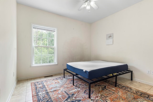 tiled bedroom with ceiling fan