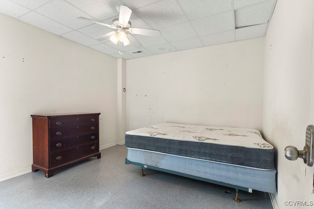 bedroom featuring ceiling fan and a paneled ceiling