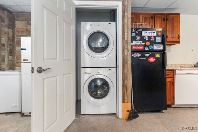 washroom featuring stacked washing maching and dryer