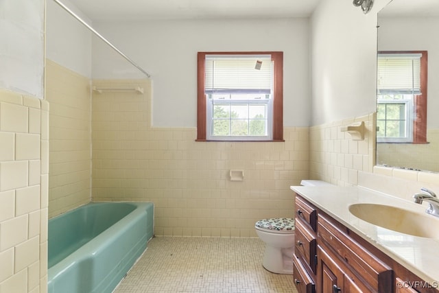 full bathroom featuring tile patterned flooring, tile walls, a healthy amount of sunlight, and vanity