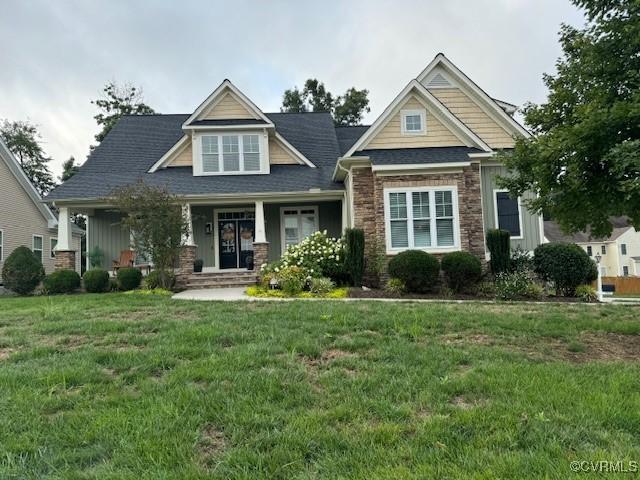 craftsman-style house with a front lawn