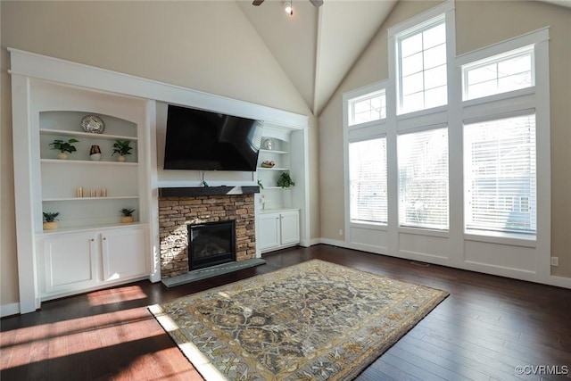 living room featuring a fireplace, built in features, and dark hardwood / wood-style floors