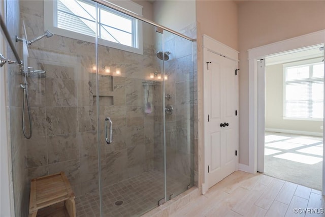 bathroom featuring a wealth of natural light and walk in shower