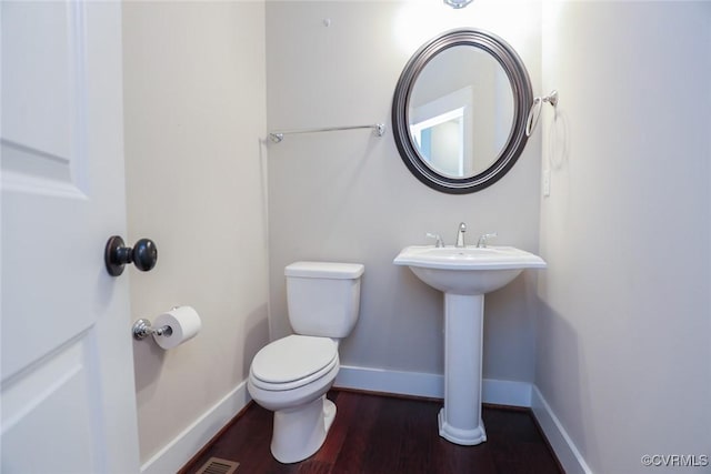 bathroom featuring sink, hardwood / wood-style floors, and toilet