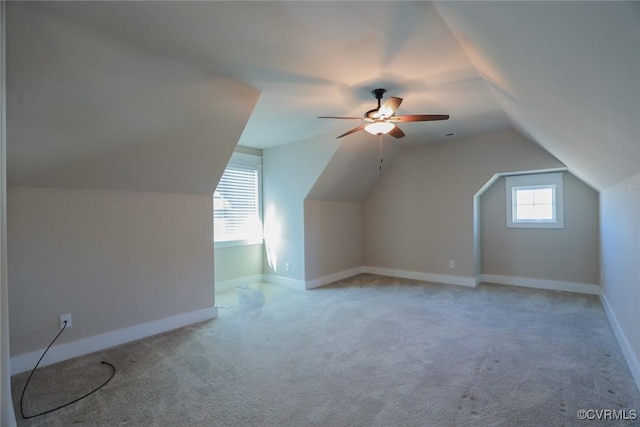 additional living space with carpet flooring, vaulted ceiling, and ceiling fan