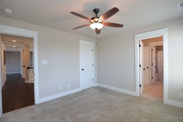 unfurnished bedroom with ceiling fan and light colored carpet