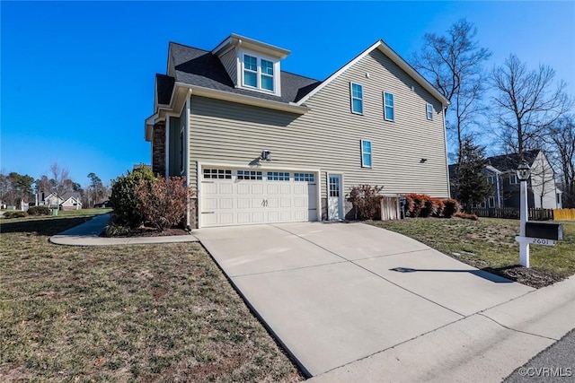 view of side of home featuring a garage and a yard