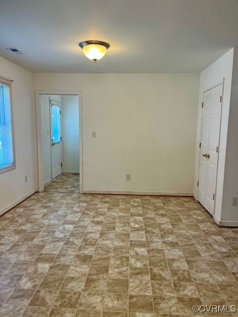 unfurnished room with light tile patterned flooring