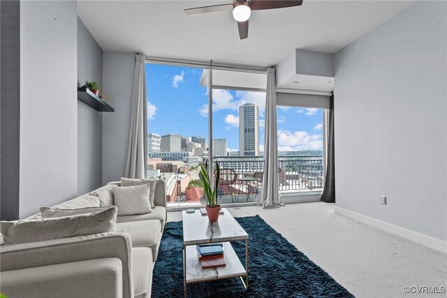 living room with carpet floors, ceiling fan, and floor to ceiling windows