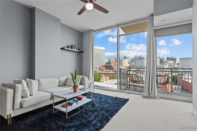 carpeted living room featuring ceiling fan