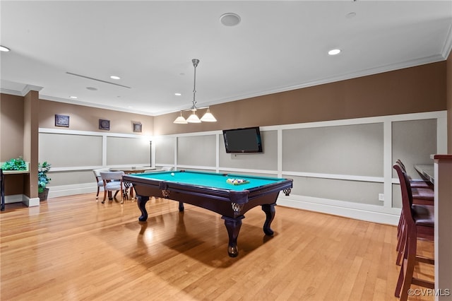 rec room with pool table, light hardwood / wood-style flooring, and ornamental molding