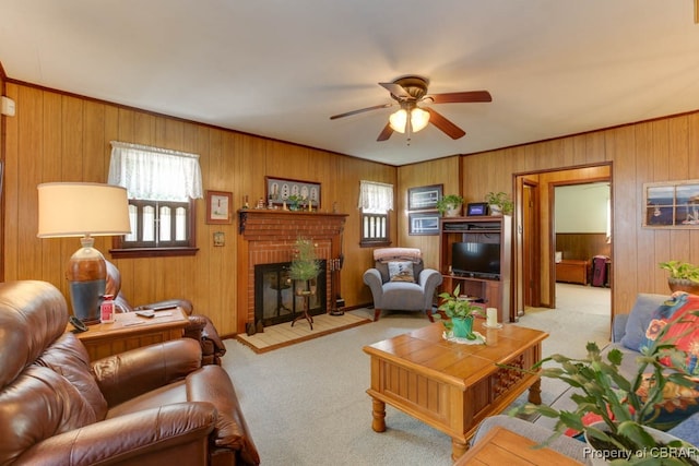 living room with light colored carpet, wood walls, a brick fireplace, and ceiling fan