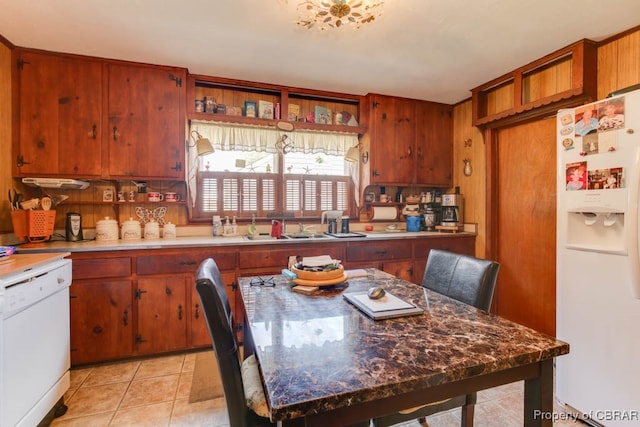 kitchen featuring sink, white appliances, and light tile patterned floors