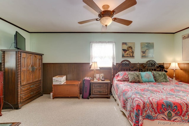 carpeted bedroom with ceiling fan and crown molding