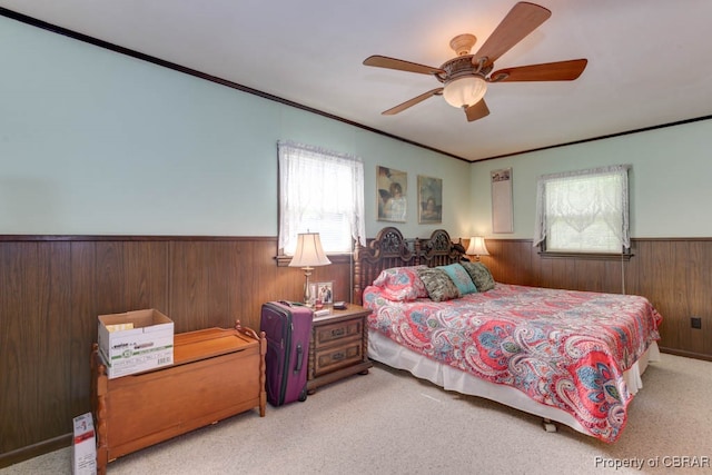 bedroom with multiple windows, light carpet, crown molding, and ceiling fan