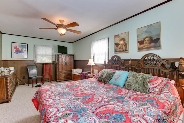 bedroom featuring ceiling fan, crown molding, and carpet flooring