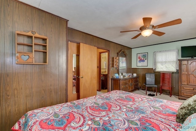 carpeted bedroom with wood walls and ceiling fan