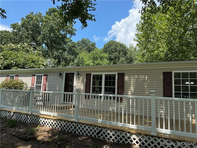 back of property featuring a wooden deck