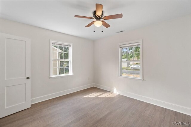 unfurnished room with ceiling fan and hardwood / wood-style flooring