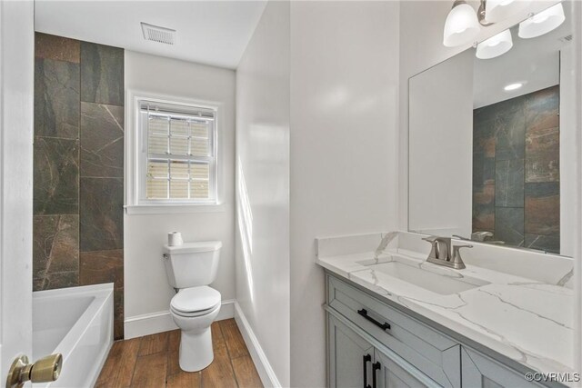 bathroom featuring hardwood / wood-style flooring, vanity, and toilet