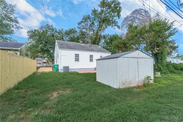 exterior space with a lawn and central AC unit