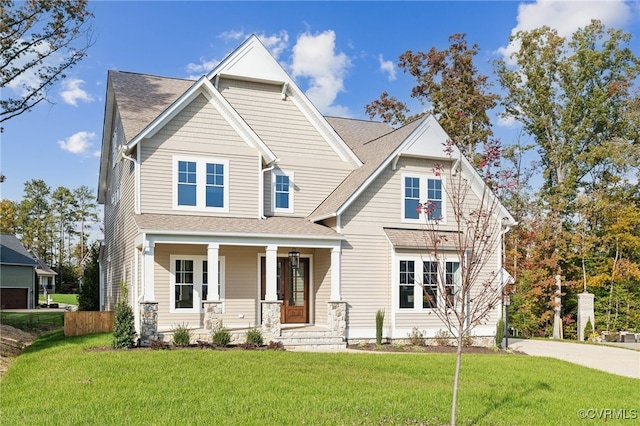 craftsman house with a front yard and a porch