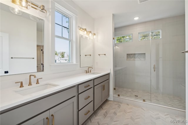 bathroom with vanity and a shower with shower door