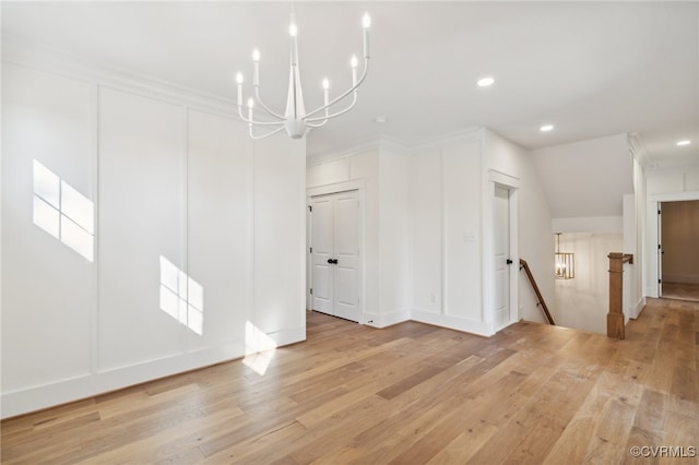 unfurnished dining area with ornamental molding and light wood-type flooring