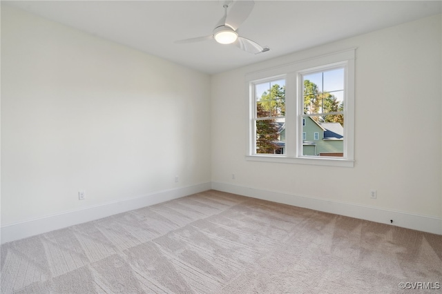 unfurnished room featuring ceiling fan and light colored carpet