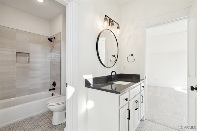 full bathroom featuring toilet, tiled shower / bath, vanity, and tile patterned flooring