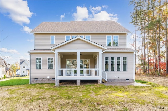 rear view of house with a yard and a porch