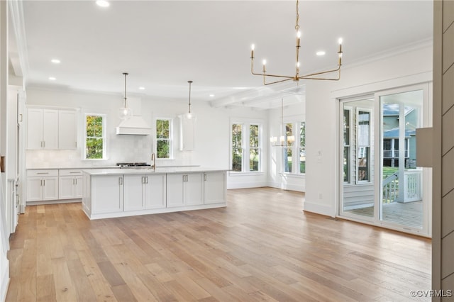 kitchen featuring white cabinetry, a healthy amount of sunlight, and light wood-type flooring