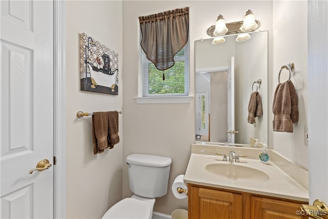 bathroom with toilet and vanity